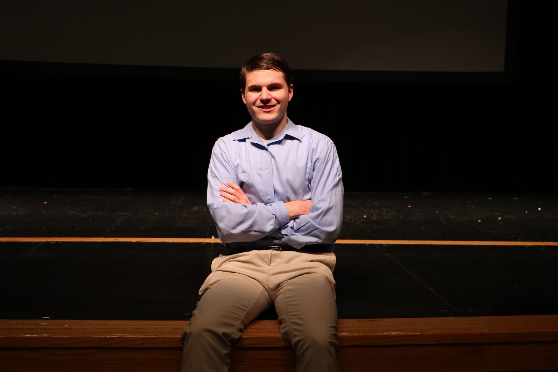 Evan Conover sitting on the stage